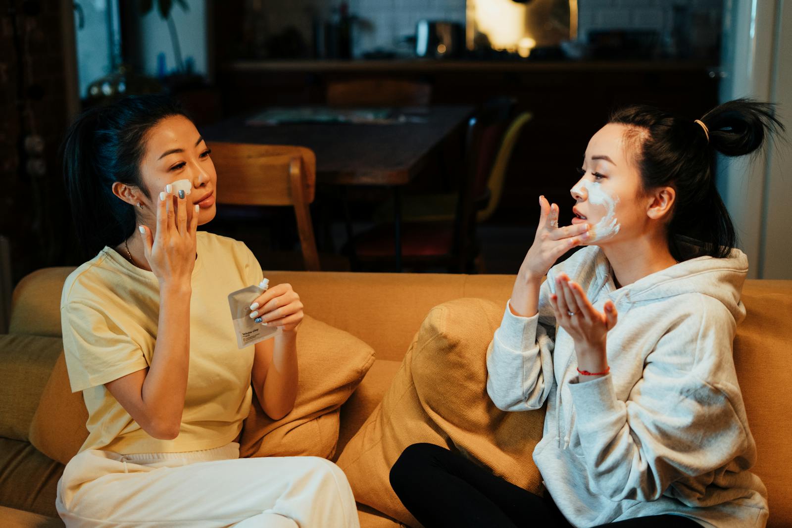 Two friends enjoy a relaxing skincare session at home, enhancing their beauty routines together.