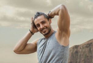 man in gray tank top smiling