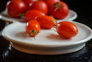 red tomatoes on white ceramic plate