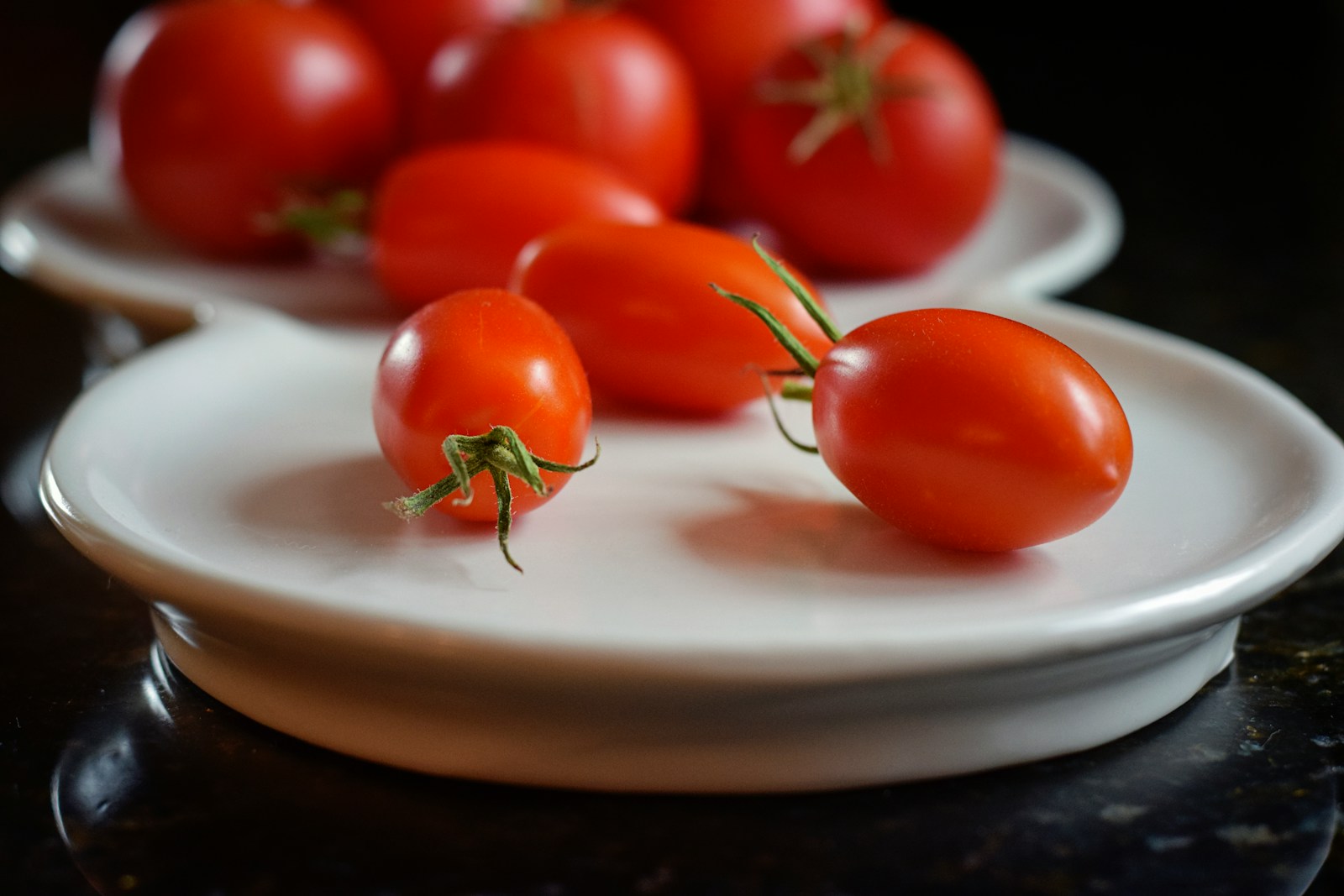 red tomatoes on white ceramic plate