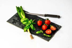 slice of tomato on board beside knife